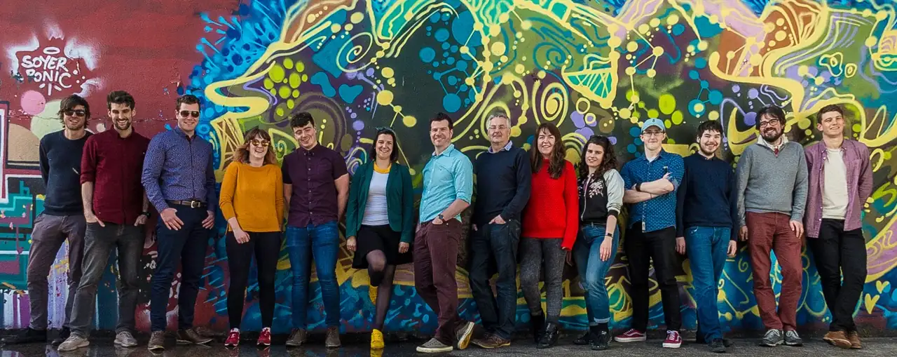 The Ex Ordo team standing in front of colourful graffiti by Silver Strand